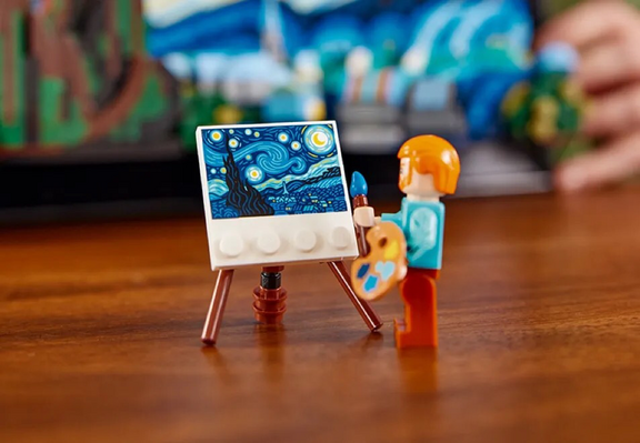 A LEGO Vincent van Gogh painting a LEGO-sized Starry Night.