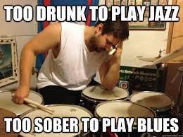 Photo of man slumped over drum kit, captioned "Too drunk to play jazz, too sober to play the blues"