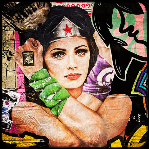A colour Hipstamatic photo of a piece of street art that is a cartoon Wonder Woman
