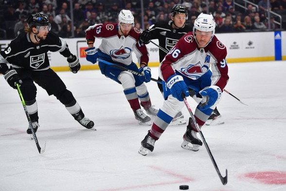 Dec 3, 2023; Los Angeles, California, USA; Colorado Avalanche right wing Mikko Rantanen (96) plays for the puck against the Los Angeles Kings during the first period at Crypto.com Arena. Mandatory Credit: Gary A. Vasquez-USA TODAY Sports