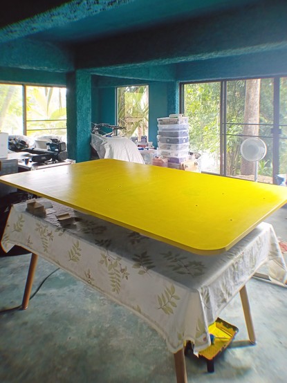 Studio desk in the workshop with view through the windows into the Thai jungle.
