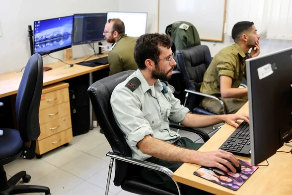 Reuters, 2023 - Technologists with the Israeli army's Matzpen application and data operations unit work at their station, at an IDF base in Ramat Gan, Israel Palestine