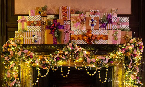 Presents and garland decorating the mantle piece in the Music Room at Longwood Gardens