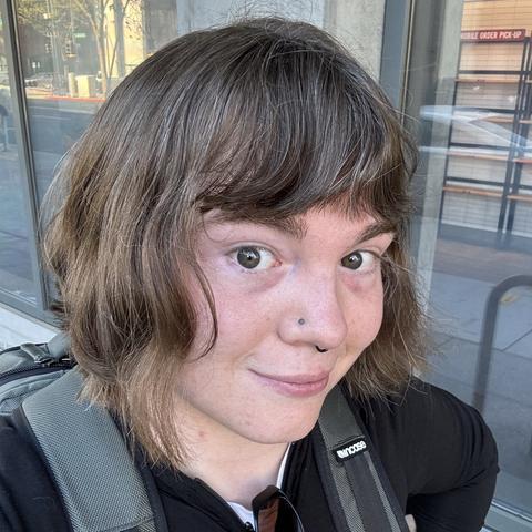 Selfie of Ricky. They have a bob-like haircut.