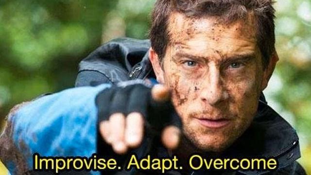 Bear Grylls (from the TV show "Man vs. Wild"* with a filthy-smudged face and dirty outdoor jacket looking at the viewer and pointing at them saying: "Improvise. Adapt. Overcome"