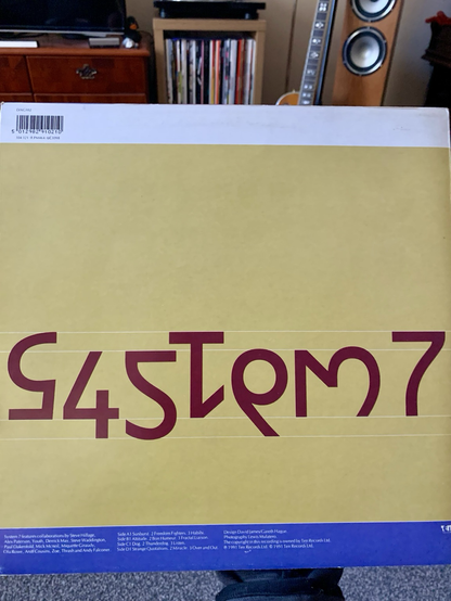 Rear cover is numbers arranged to read ‘System 7’ in a clever way.