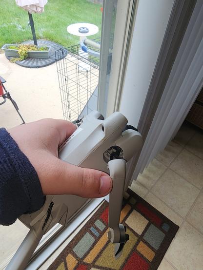 A DJI Mini 3 Pro quadcopter. The front right arm has snapped off.