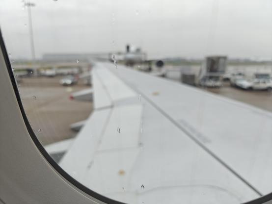 A plane wing visible from a plane window.