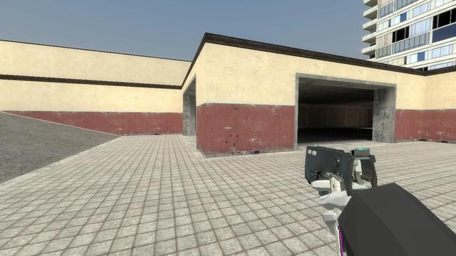 me holding the Alyxgun, a pistol with some really cool looking attachments, with my right (mechanical) hand on gm_construct