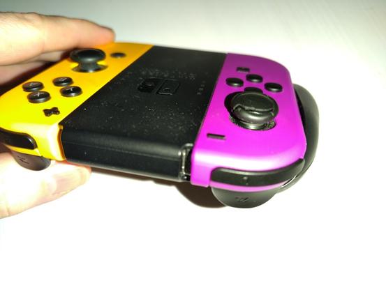 Nintendo Switch controller, the rubber of the joystick of the purple joycon is damaged.