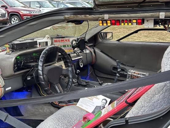 A DeLorean’s interior modified like "Back to the Future’s" time machine, featuring glowing buttons, time circuits, and a hoverboard.
