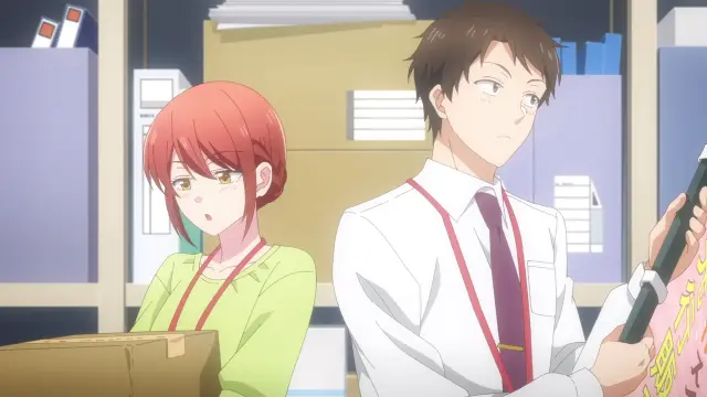 Two main characters in a storage room blushing
