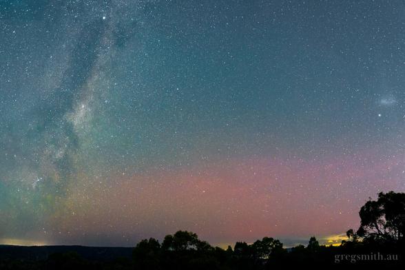 Faint red glow from aurora australis, pictured next to the Milky Way.