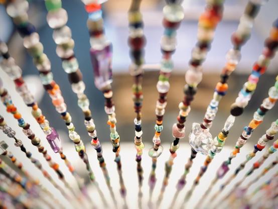 Colorful, hanging beads cascade down out of focus.