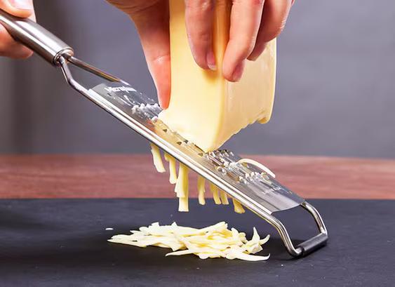 Grating cheese with a handheld cheese grater