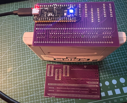An image with a Super Famicom game being read by a raspberry pi pico, all assembled on a PCB board