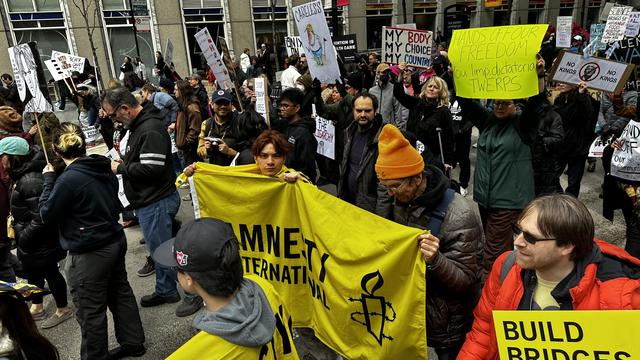 #Chicago #HandsOff #Protests 

#AmnestyInternational was there.

A sign says "Hands Off #OurFreedoms, You Limp Dictatorial #Twerps"

Also "#MyBody #MyChoice #MyCountry"