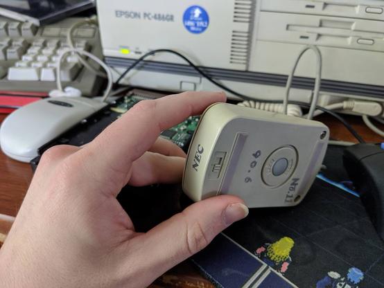 Outside of mouse, looks like any other late PC-9801/early 9821 mouse. Old NEC logo. Underside shows the DPI setting switch.