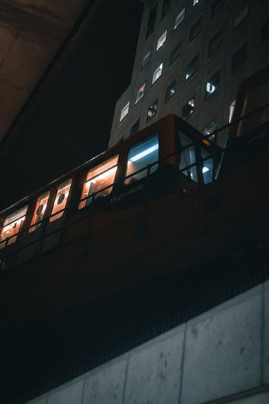 Train running through London at night.