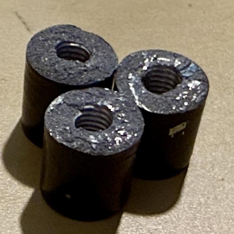 Three sheared off metal parts that have a threaded hole through them where the 3D printer’s bed is meant to be bolted down to the rails these were a part of.