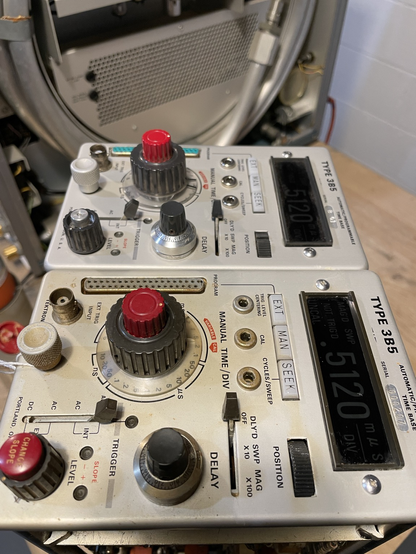 Two identical oscilloscope plug-ins, one in the process of being cleaned.