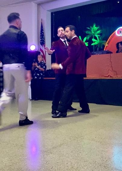 After hurriedly dancing to the far end of the dance floor, as though running from Leonardo, Nicolás puts out a hand, his expression pleading Leonardo not to steal Germán away from him.