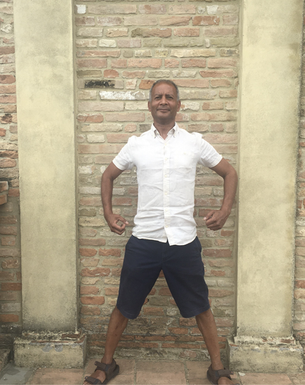 John Domingue standing strong in front of a mural on the balcony of Bertinoro Castle back in 2022.