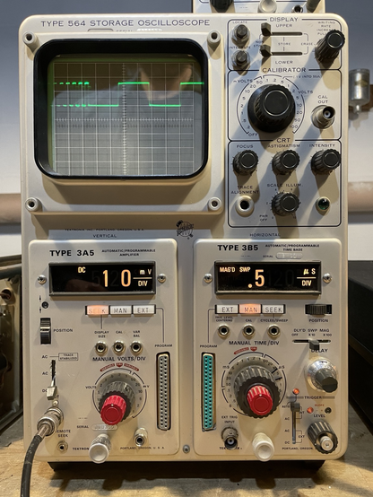 The oscilloscope displaying a waveform where the right hand portion of the display is magnified