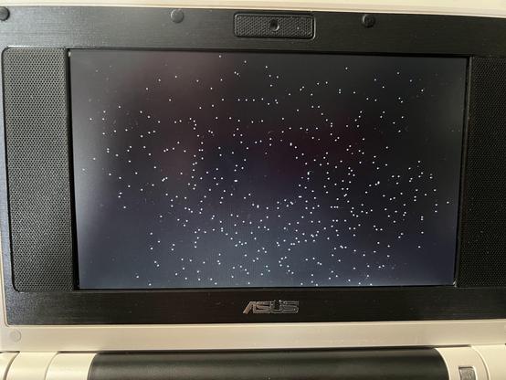 Picture of a notebook screen. The screen is black and filled with white dots in a circular pattern.