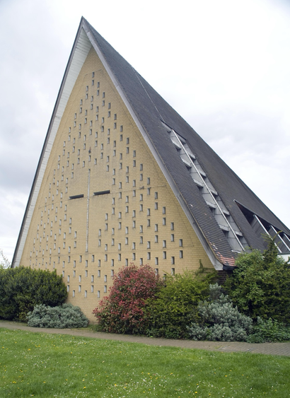 A colour photograph of the church of St John in Hatfield with its steeply pitched roofline