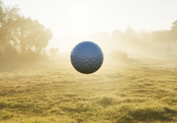 golfball suspended in mid-air, backlit through sunlit mist and shadowy trees