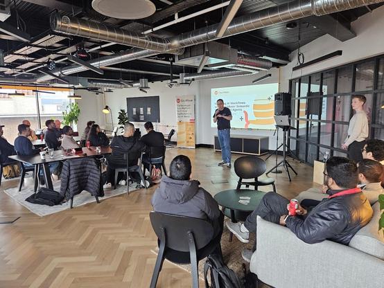 A photo of the audience from a different angle to the other photo. A representative of couchbase is addressing the audience