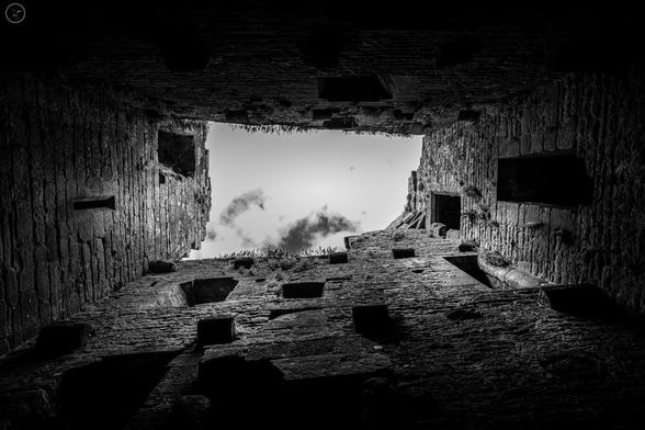 Monochrome shot looing up through ruined castle tower