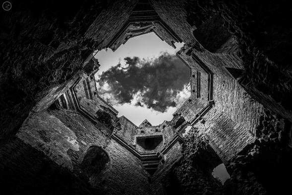 Monochrome shot looing up through ruined castle tower