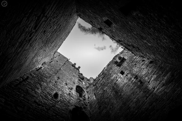 Monochrome shot looing up through ruined castle tower