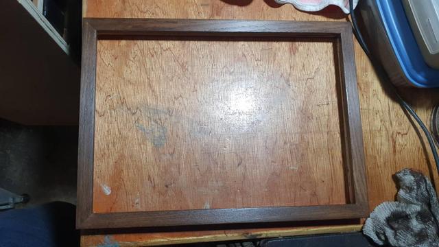 Walnut picture frame on a worktop bench.