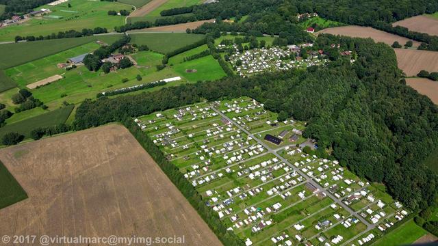 An aerial view of a campsite in Oer-Erkenschwick with farm yards and trees around.
