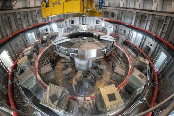 Installation of the first superconducting magnet, Poloidal Field Coil #6.