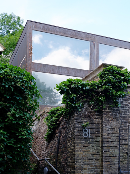A colour photograph of 81 Swains lane, a corten steel and glass house by John Winter