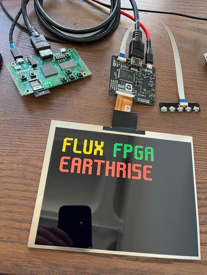 LCD panel shows "FLUX FPGA EARTHRISE" in angular, geometric font.