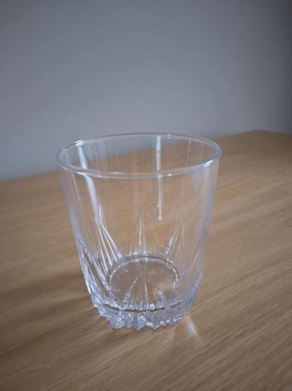 A glass with a decorative bottom. Used to be a mustard jar.