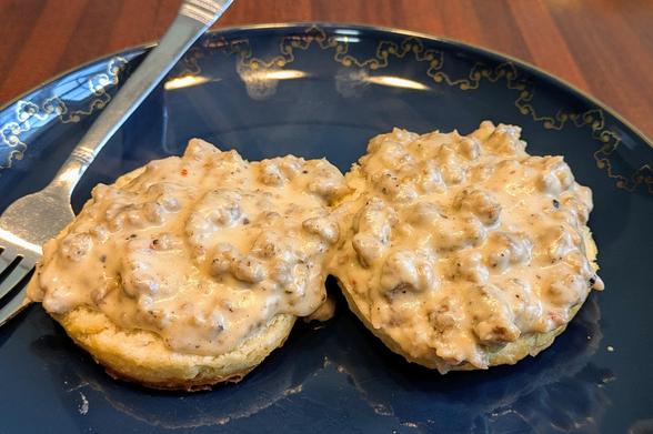 Sausage gravy served over two biscuit halves.