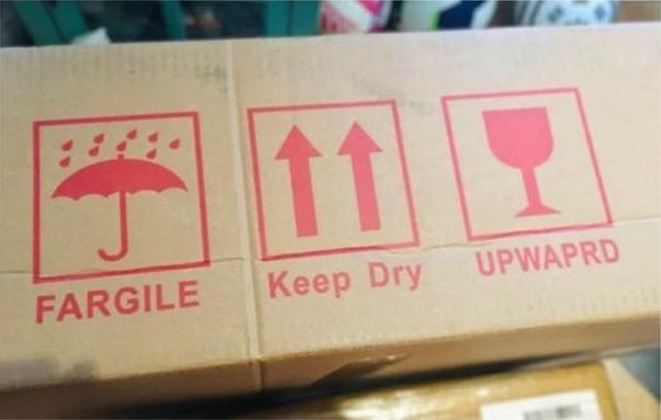 the side of a box, and inside three red squares, in red ink:
an umbrella with rain on it, label: Fargile [sic]
two arrows pointing up, label: Keep Dry
a wine glass, label: unwaprd