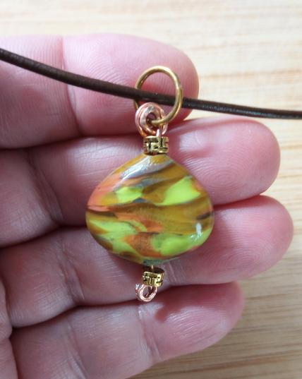 Lampwork glass pendant in earth tones.