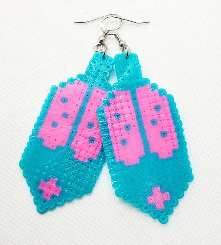 a pair of perler beaded eagle feather earrings made by kiamichi in vibrant teal and pink