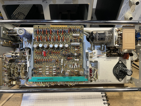 The inside of a 1960s hybrid solid state / vacuum tube oscilloscope plugin.