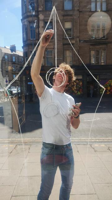 looking out the front window of the bookshop as bookseller Jack paints a giant pen nib on the glass for the British Book Awards