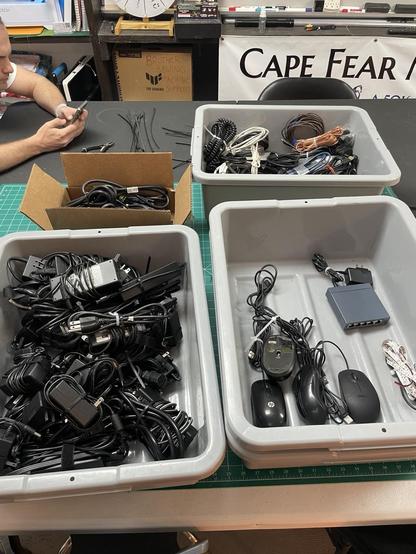 Picture of the plastics bins now containing a much reduced pile of cables and all organized.