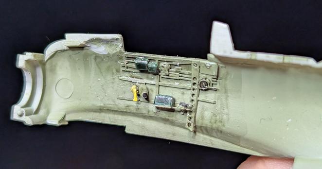 Inside of the right side of the fuselage of a 1 to 72 model kit for a zero with painted cockpit details