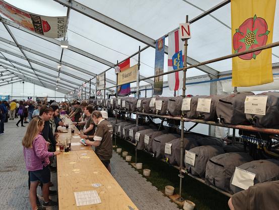 A long tent with hundreds of beer casks